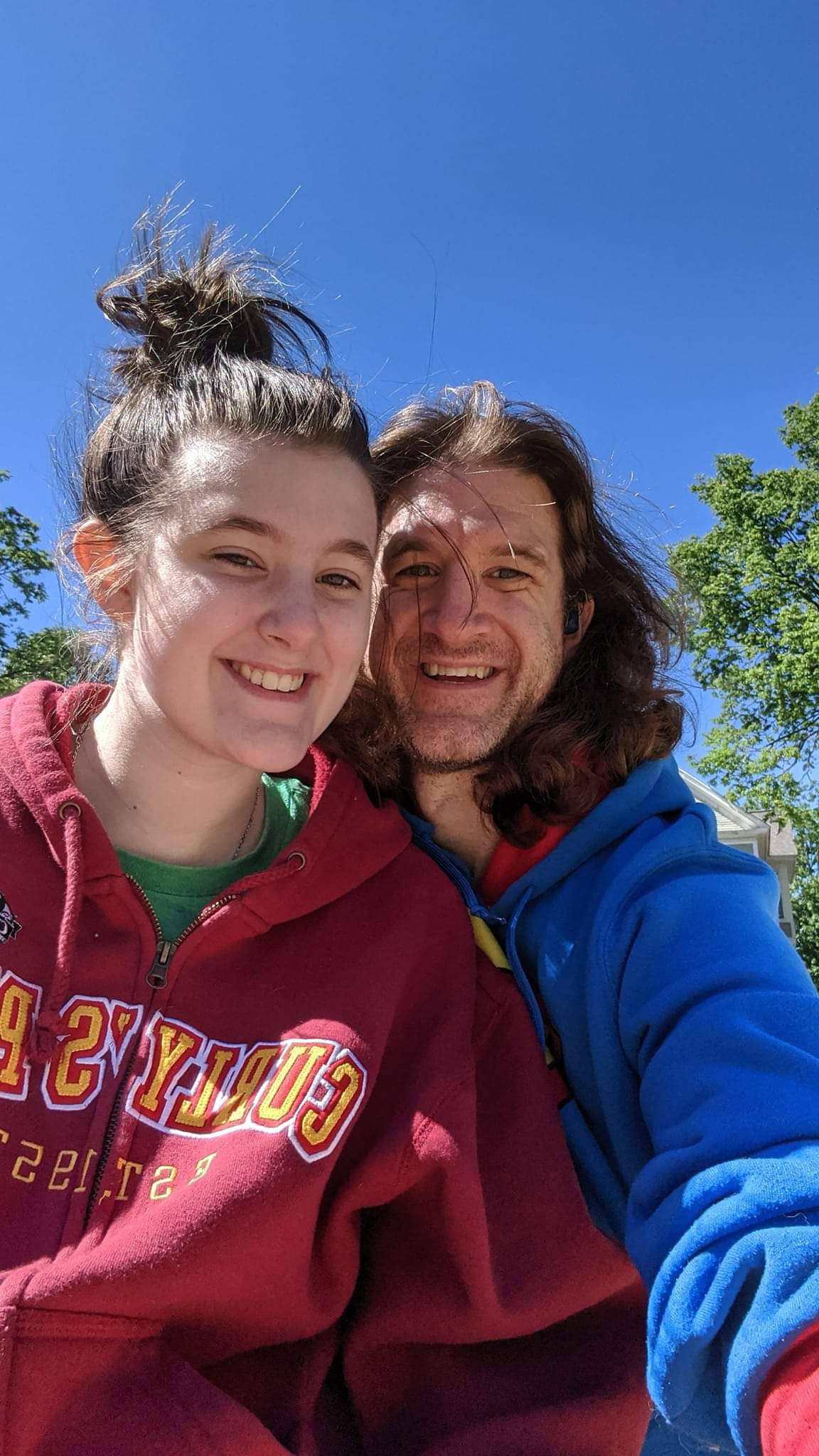 Brian smiling with family outside